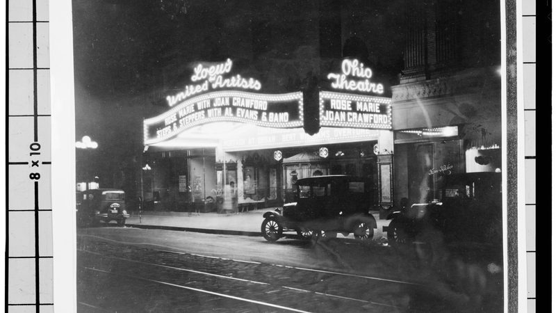 A vintage movie theater marquee lit up at night
