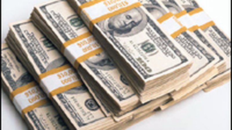 Stacks of US dollar bills — founder wealth is equity, not salary