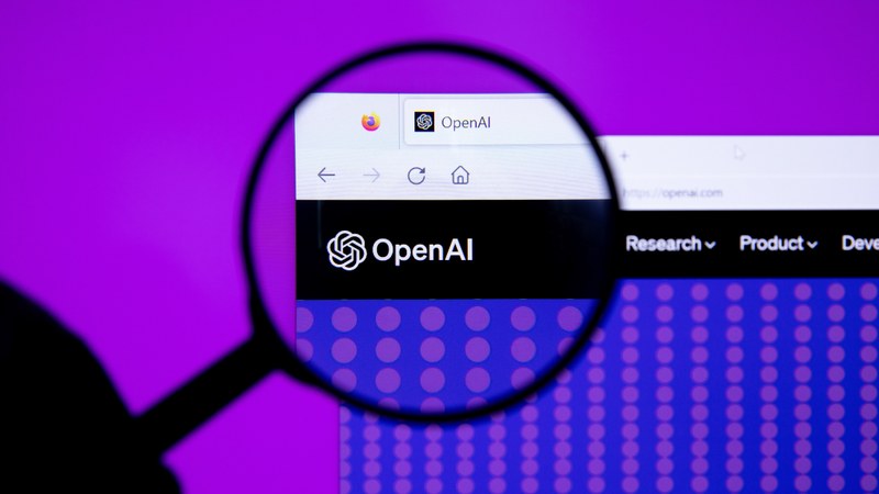 The OpenAI logo photographed under a magnifying glass