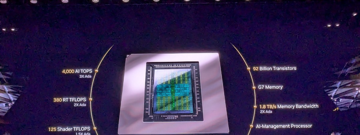 Jensen Huang holding an Nvidia RTX Blackwell chip on stage at CES 2025
