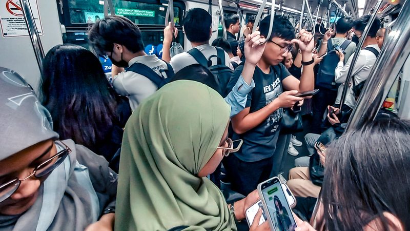 Smartphone users scrolling short video — the attention economy Zhang Yiming helped invent