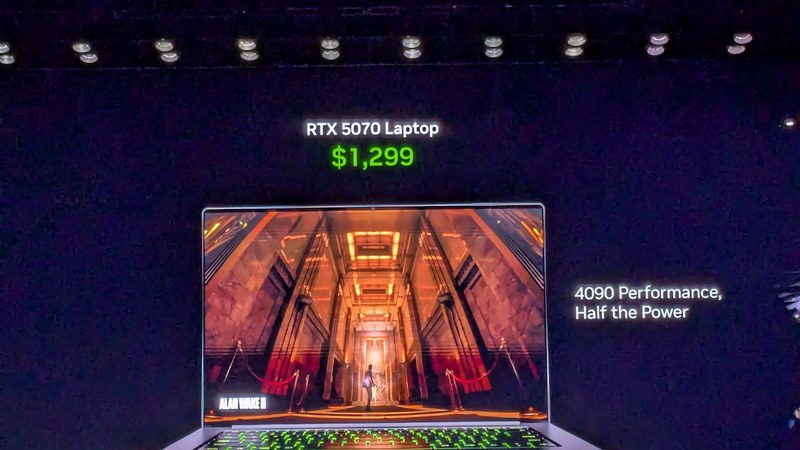 Jensen Huang holding an Nvidia RTX chip on stage at a keynote