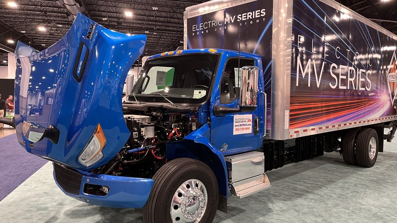 White electric box truck on display at an auto show