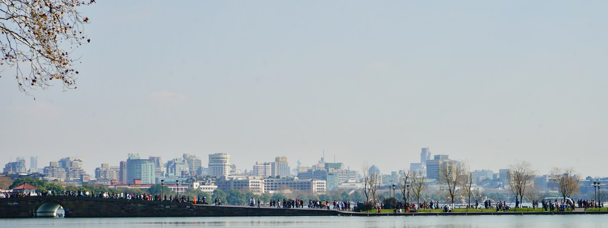 Hangzhou skyline across West Lake — home of DeepSeek and High-Flyer headquarters