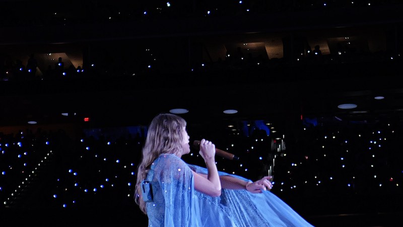 Taylor Swift performing on stage during a stadium concert