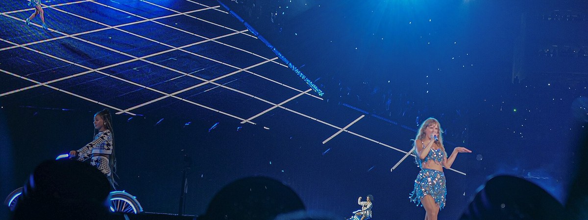 Taylor Swift performing on the Eras Tour stage in concert