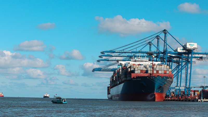 A container ship at a container terminal — Adani Ports is India's largest private port operator